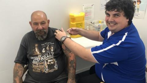 Pharmacist Andrew Gilberto from Hinchinbrook Community Pharmacy vaccinates a patient