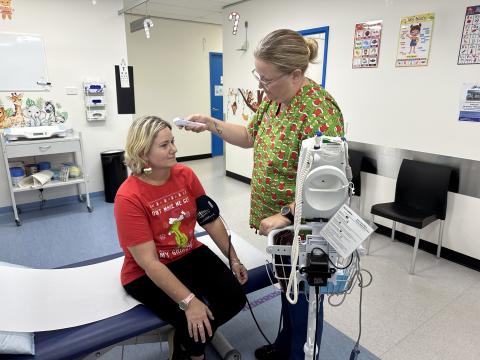 Nurse Andrea Mosbauer attends to Natalie Shand at the Cairns South Urgent Care Clinic, next to Balance! Edmonton Family Practice.