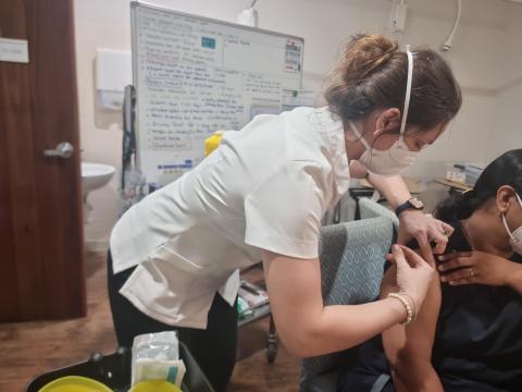 Pharmacist delivers vaccine to patient