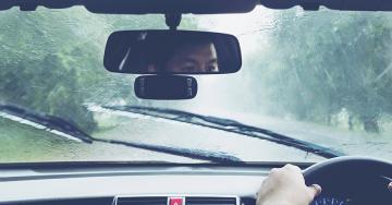 Man driving car in heavy rain