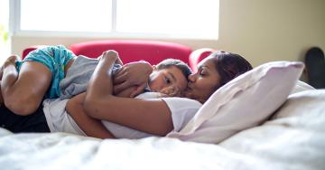 Mother comforting sick child